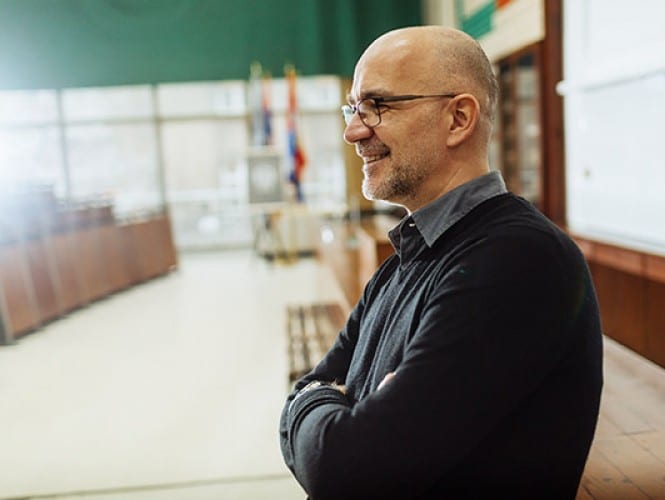 A man standing in a classroom. 