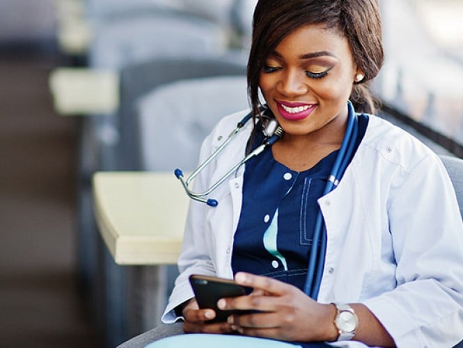 Image of a doctor on a cellphone.