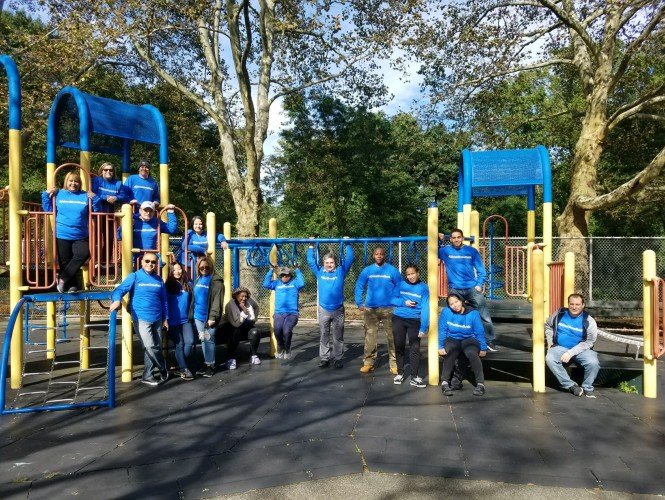Dime Community Bank employees standing in playground. 