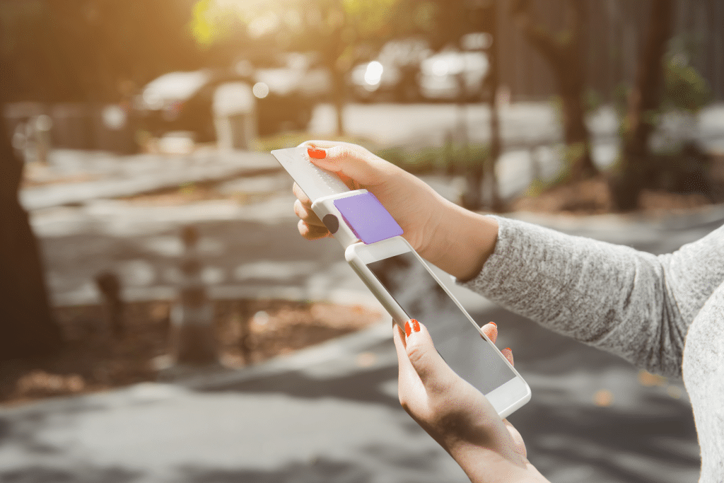 A person taking a payment on their phone.