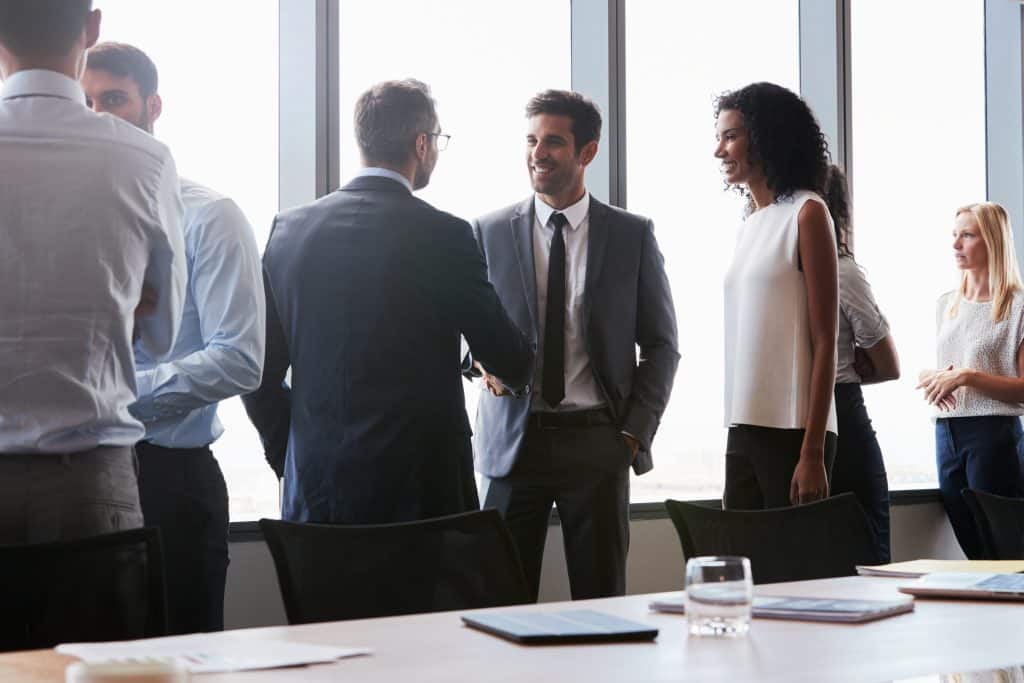 Business professionals talking in a board room. 